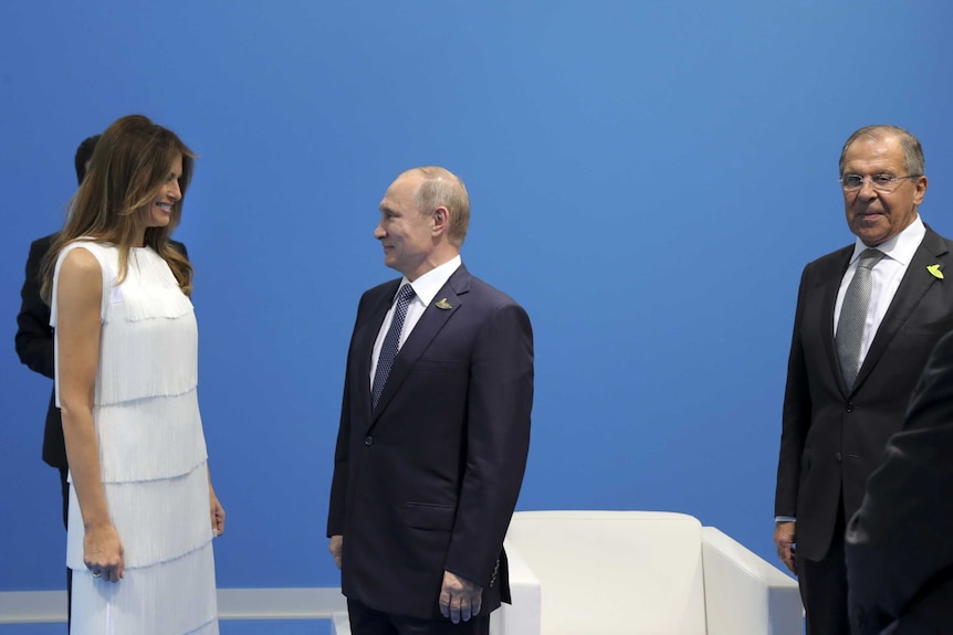 Melania Trump wears a white fringe dress to meet vladimir putin as sergey lavrov stands awkwardly to the side