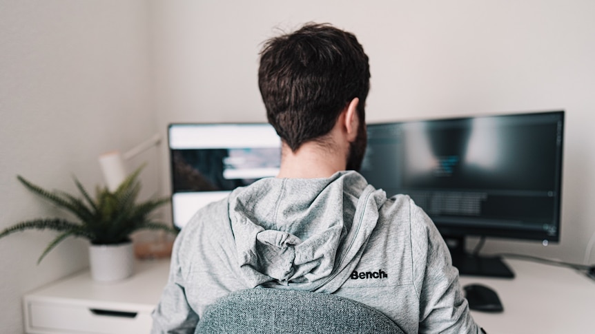 A man on his computer, working from home.