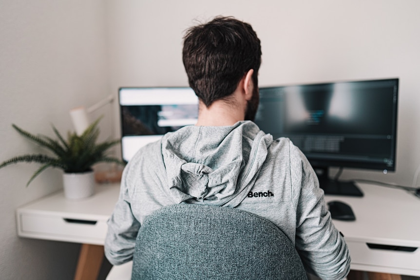 A man on his computer, working from home.