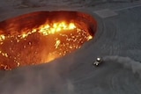 The president of Turkmenistan has appeared on state television driving a rally car to a flaming gas crater.