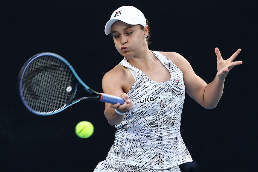 An Australian female tennis player hits a forehand at the Australian Open.