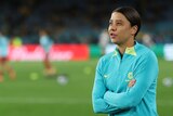 Sam Kerr stands on the sidelines with her arms folded during warm-ups for the Matildas' Women's World Cup clash with Denmark.