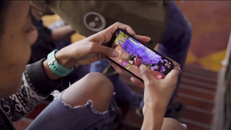 A person playing the videogame Fortnite on a mobile phone