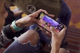 A person playing the videogame Fortnite on a mobile phone