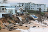 Homes topple into the sand as erosion eats away at properties. Pool on the sand