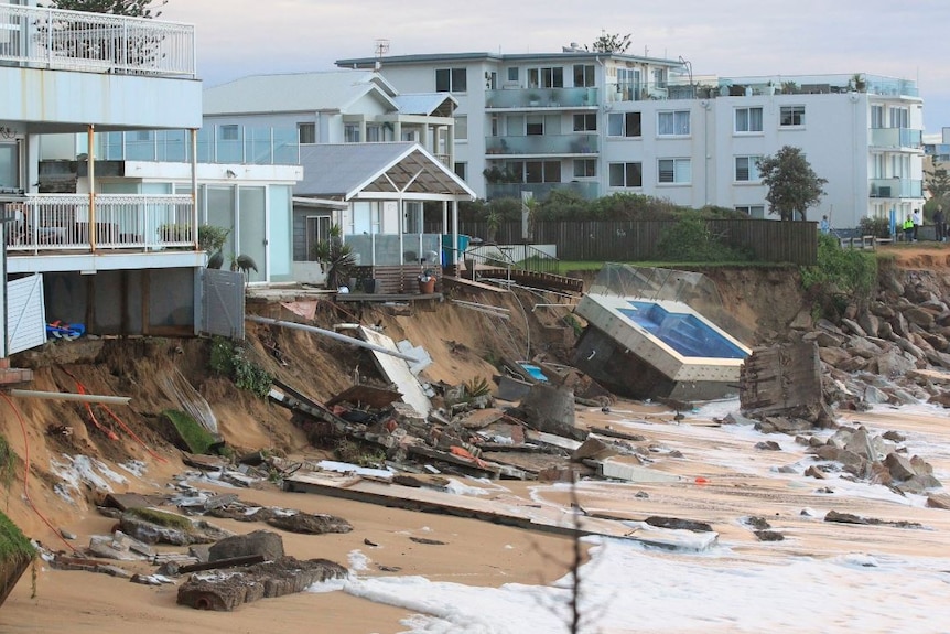 Homes topple into the sand as erosion eats away at properties. Pool on the sand