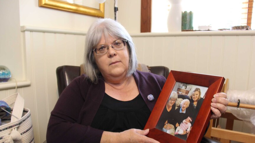 Rowena Butler holds a picture of her mother.