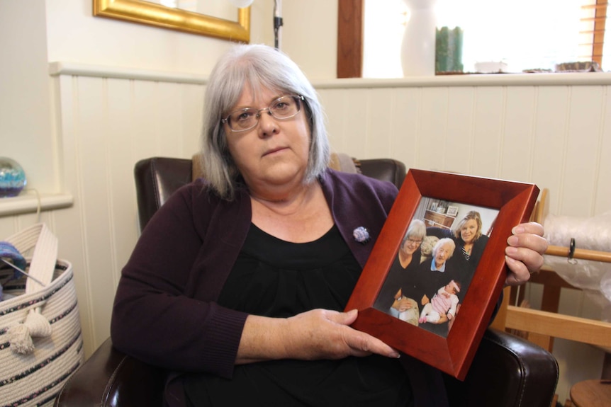 Rowena Butler holds a picture of her mother.