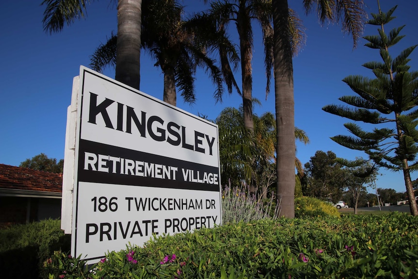 A sign outside of Kingsley Retirement Village with palm trees in the background.
