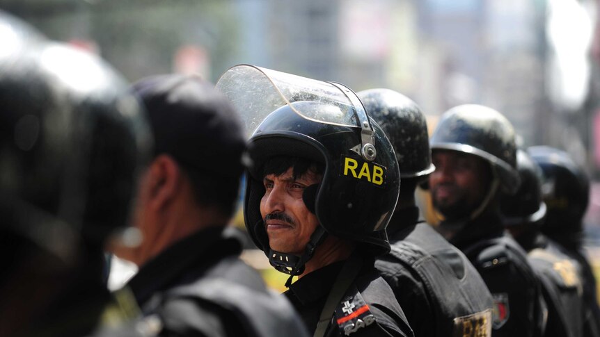 Bangladeshi Rapid Action Battalion personnel stand guard during a nationwide strike