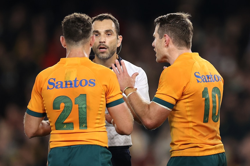 Two Wallabies players speak to the referee during the Bledisloe Cup Test.