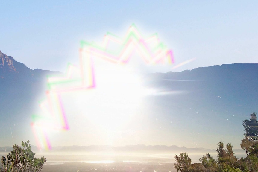 Coloured zig zags in the air with mountains in the background