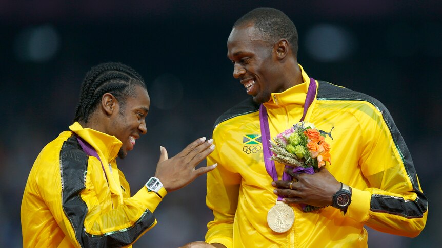 Jamaica's Yohan Blake and Usain Bolt (right) stand on the podium after receiving gold medals for the men's 4x100m relay.