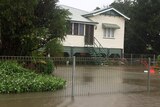 Flood waters rise around house as rain continues in Bundaberg.