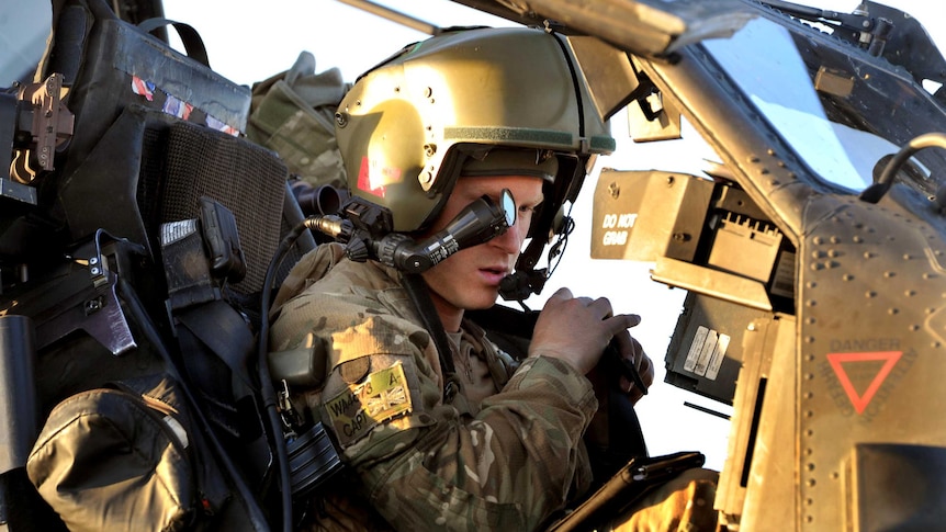 Prince Harry sits in his Apache Helicopter cockpit.