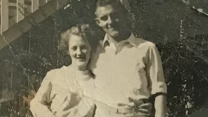 A black and white photo of George and Rosemary Dale in 1956 standing outside a house in Holland Park.