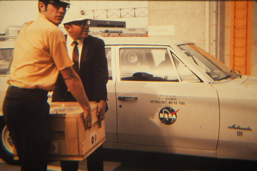 NASA staff transport payload to rocket.