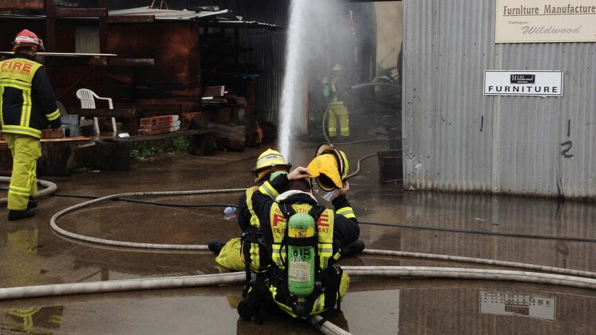 Fire crews attend at the scene of a furniture factory fire in Rich Street, Marrickville.