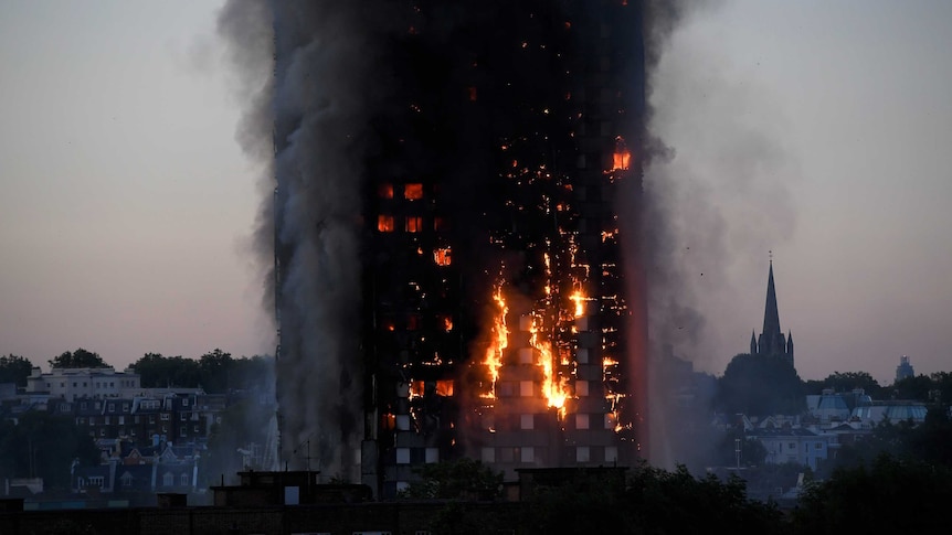 Flames and smoke billow as firefighters deal with a serious fire at Grenfell Tower in West London.