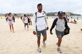 Indian cricketer Harbhajan Singh, centre, with team-mates on an impromptu visit to Sydney's Bondi Beach.