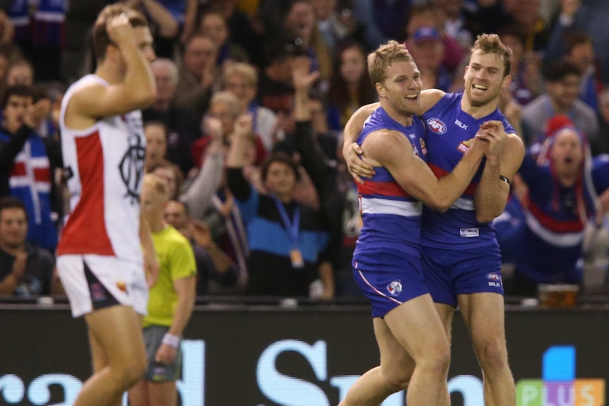 Western Bulldogs players celebrate a goal against Melbourne at Docklands