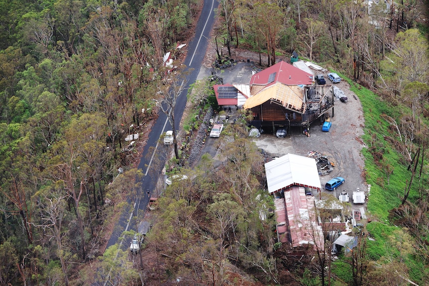 An aerial shot of a home ripped apart by storms