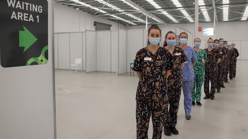 Staff in Gorman-designed scrubs lined up in vaccination hub