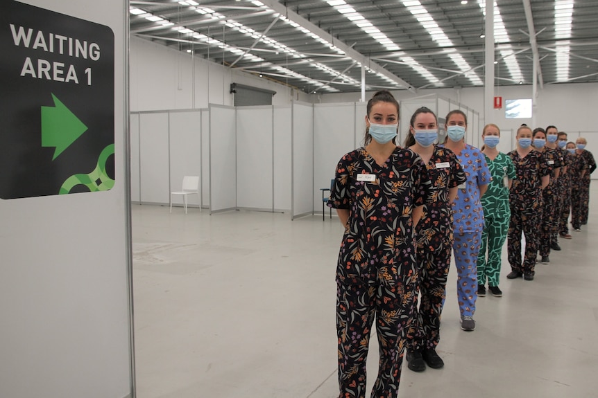Staff in Gorman-designed scrubs lined up in vaccination hub