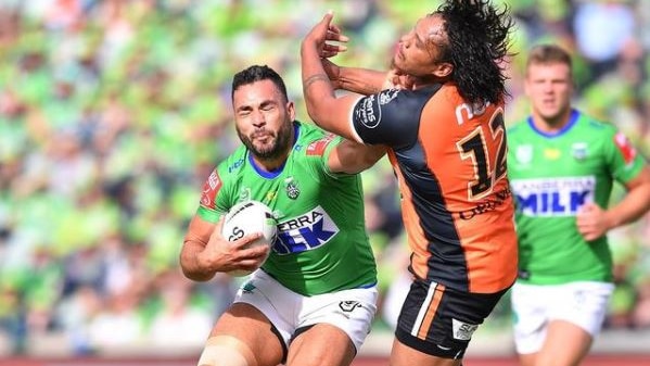 Canberra Raiders forward Ryan James fends off Wests Tigers' Luciano Leilua in their NRL clash.