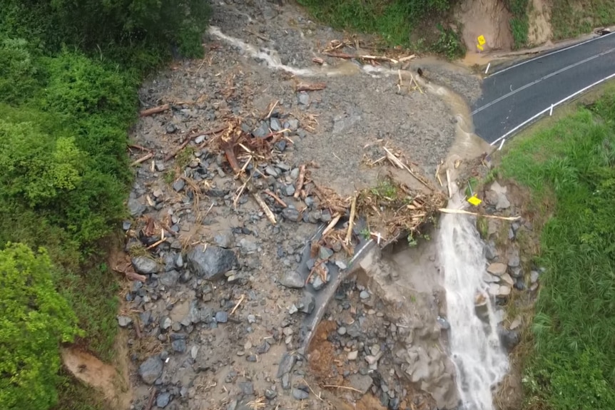 An aerial shot taken from a drone showing a large land slip on a mountain road.
