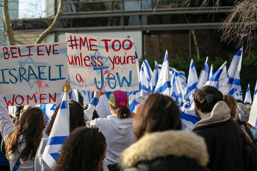 Women holding signs reading "Believe Israeli women" and "Me Too Unless You're a Jew" 