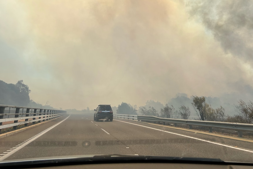 A fire engulfs a freeway