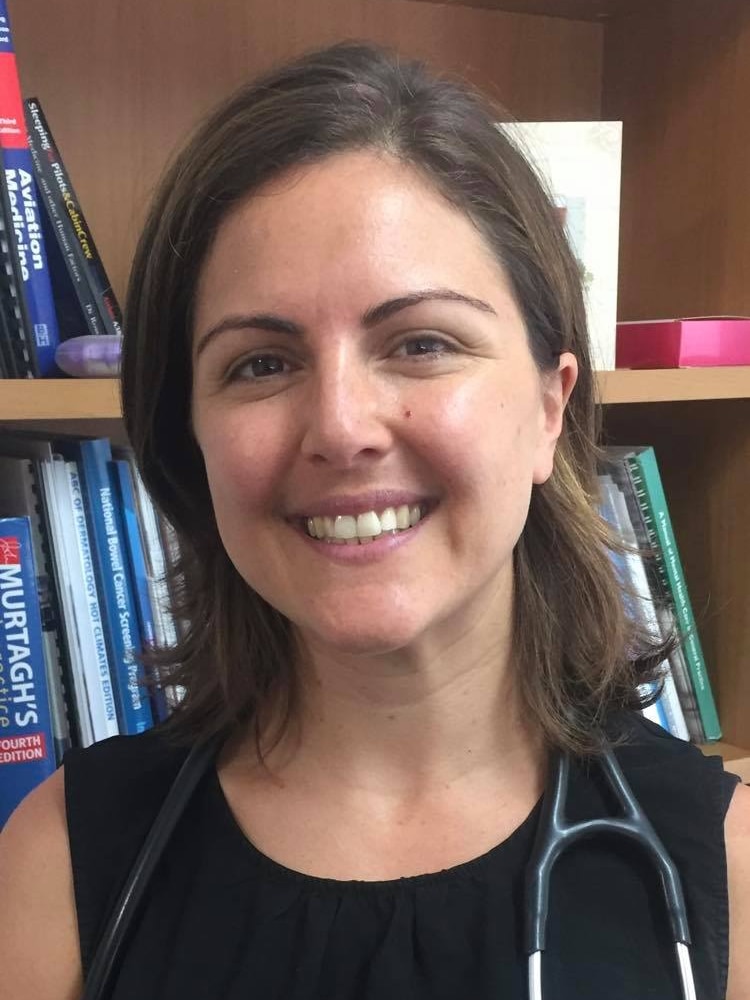 A female doctor smiles in her office 