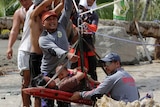 Rescuers evacuate Lenlen Medrano, who had been caught in the floodwaters.