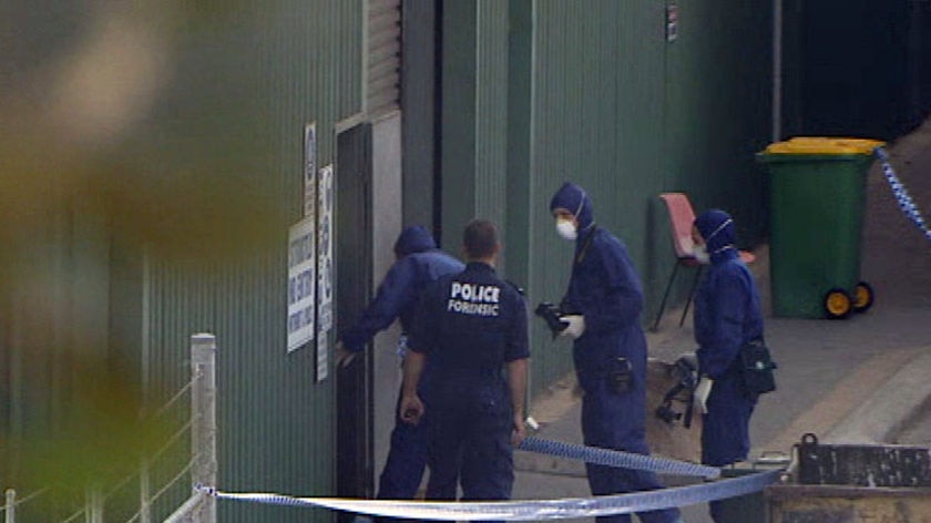 Forensic police investigating the discovery of the body of a baby in a Perth recycling plant.