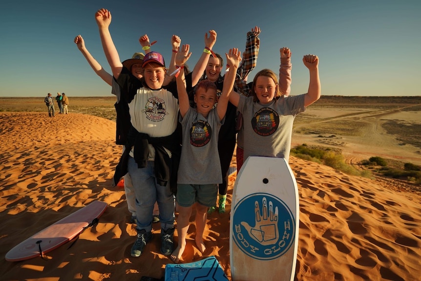 A group of kids on top of Big Red near Birdsville