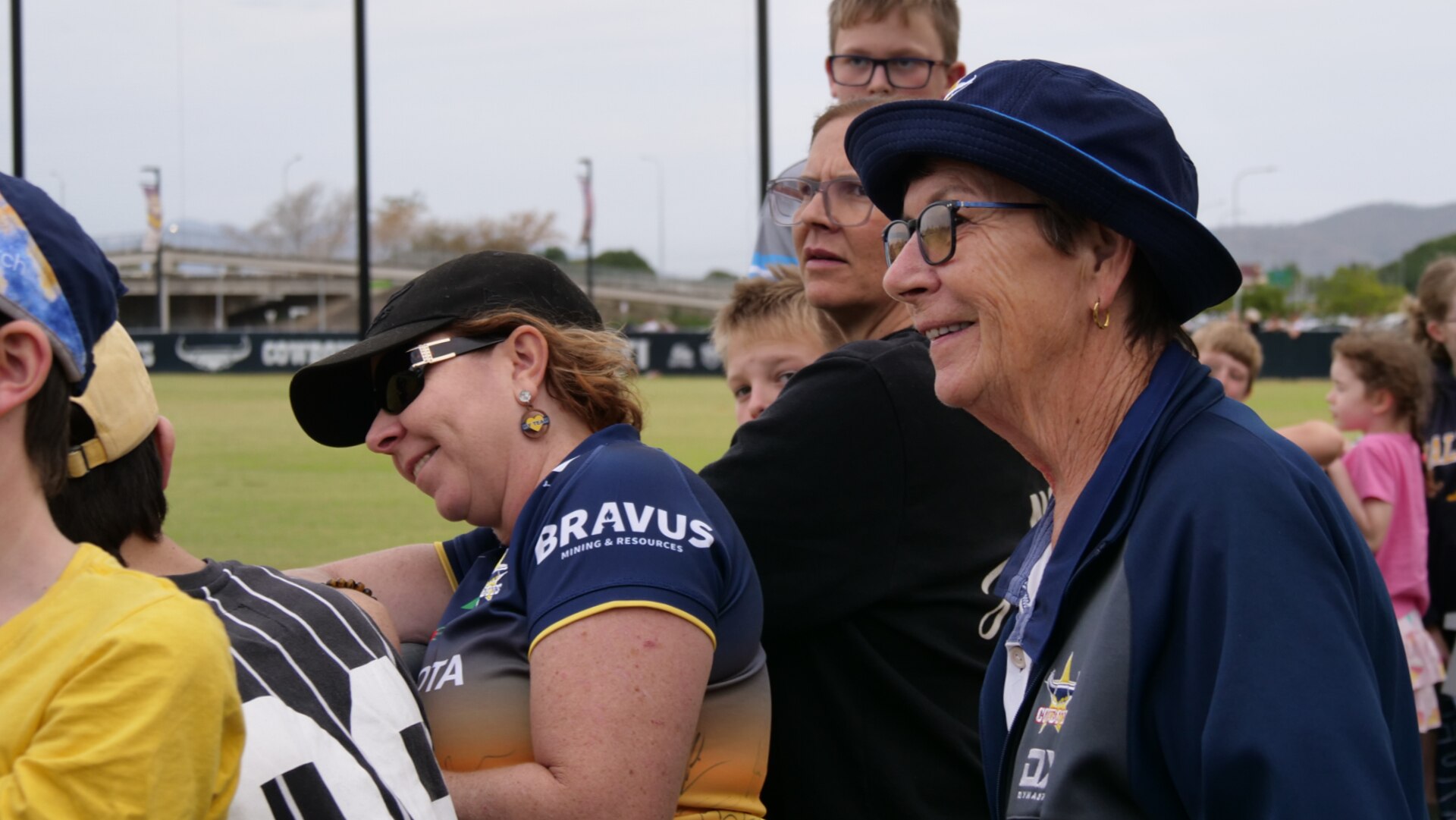 Lady joins crowd watching football field