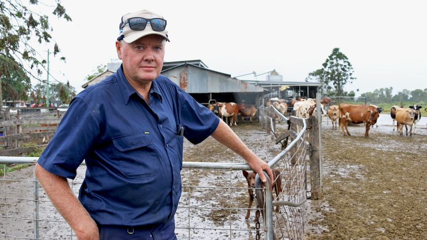 A dairy farmer stands outside his dairy.