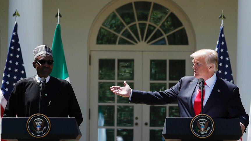 US President Donald Trump raises a hand towards Nigeria's Muhammadu Buhari
