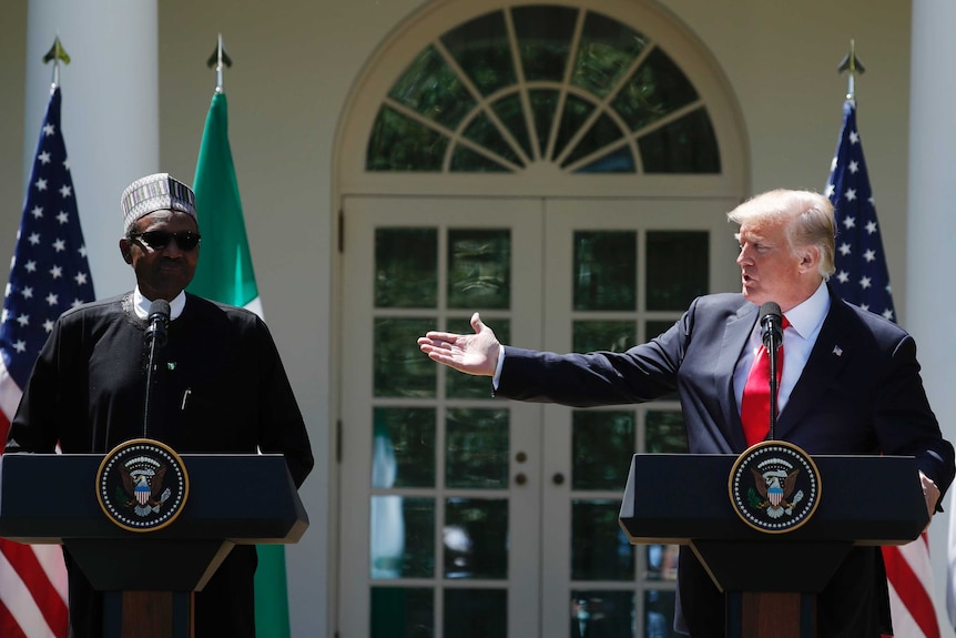 US President Donald Trump raises a hand towards Nigeria's Muhammadu Buhari