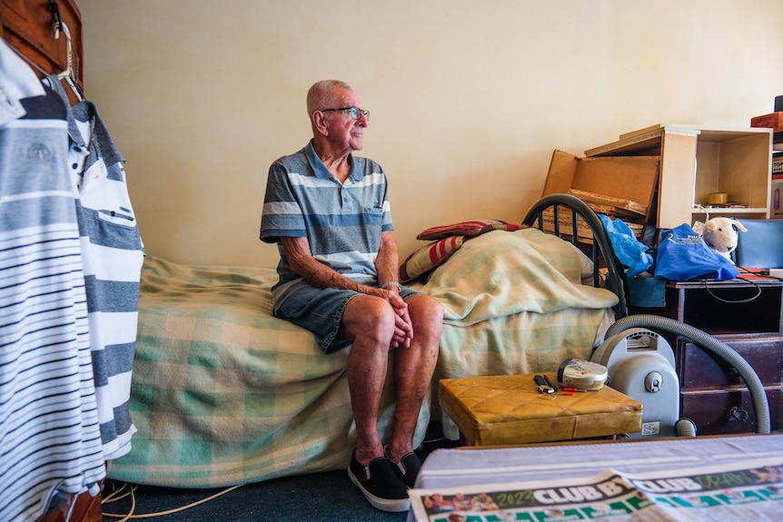 A man sitting on a bed