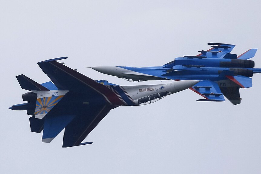 Sukhoi Su-27 fighter jets  flight past each other during a demonstration.