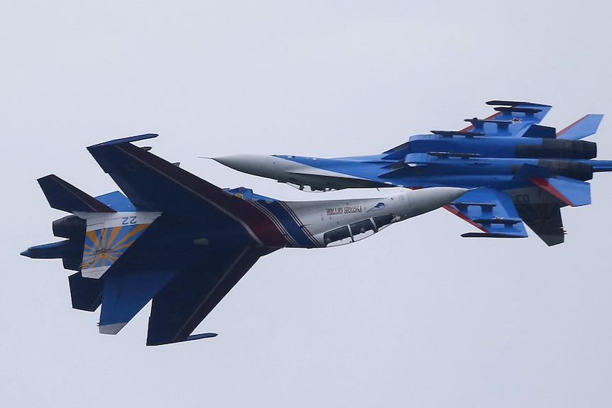 Sukhoi Su-27 fighter jets  flight past each other during a demonstration.