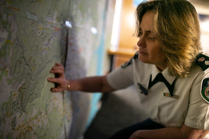 A woman looks at a map on a wall