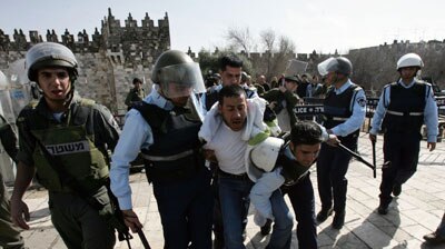 A Palestinian man is arrested by Israeli policemen during clashes in Jerusalem.
