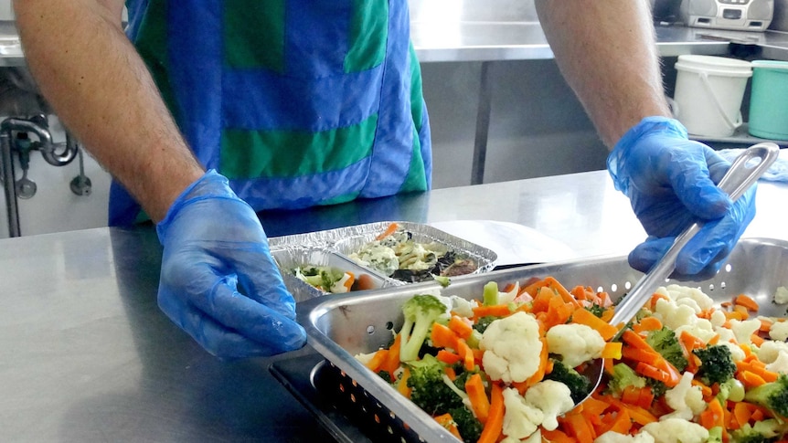 Meals on Wheels in Logan, vegetables to go with Spanish omelette prepared.