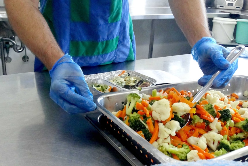 Meals on Wheels in Logan, vegetables to go with Spanish omelette prepared.