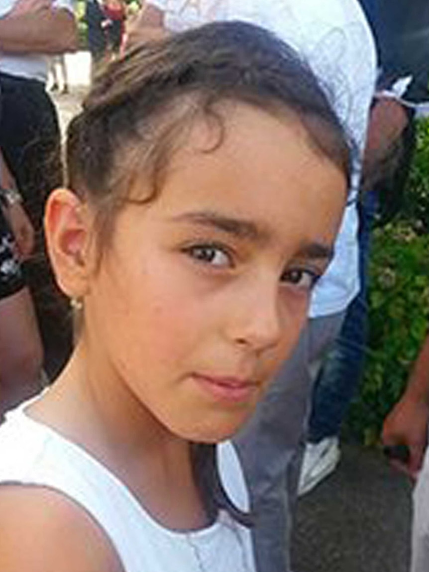 9 yo Maelys De Araujo wears her hair braided and poses for a photo