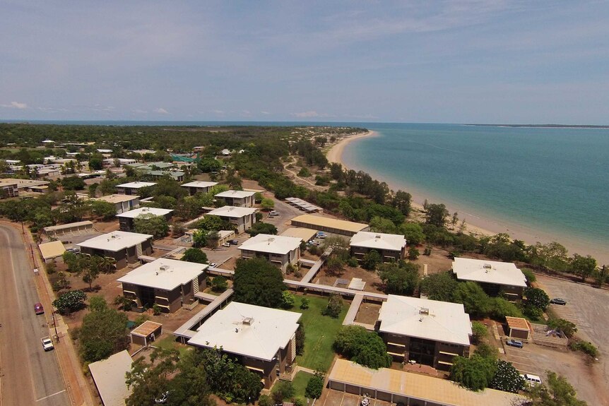 A drone photo of the town of Nhulunbuy. Blue water is in the background.