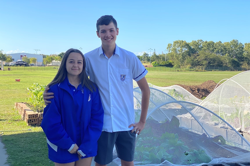 Tamlyn Nell and Aaron Bickford in front of the gardens at Mackay North State High School 